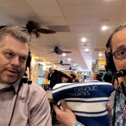 Andy Wayne of Catholic Charities blesses Nestor with the facts about feeding and helping folks in need locally