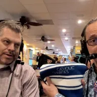 Andy Wayne of Catholic Charities blesses Nestor with the facts about feeding and helping folks in need locally